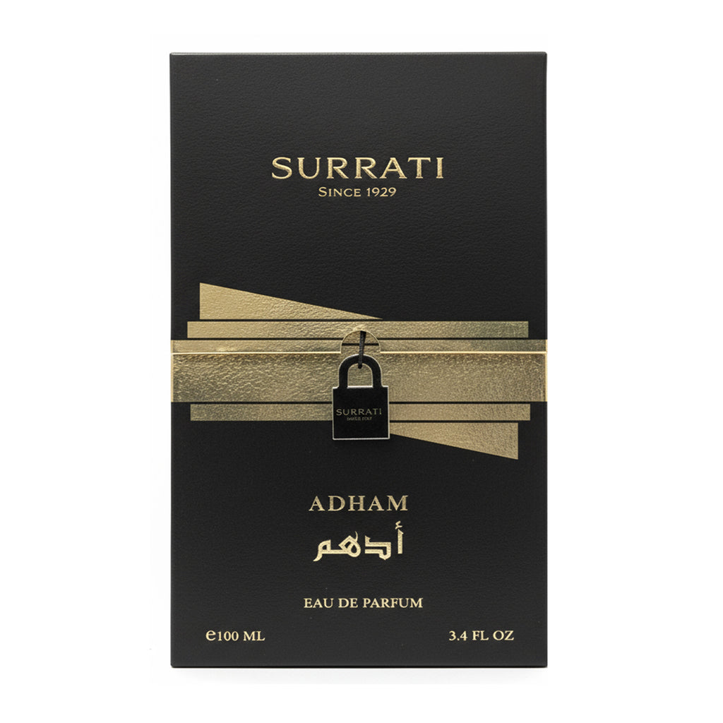 Surrati Adham Eau de Parfum box, 100 ml (3.4 fl oz), featuring a black background with gold lettering and a gold ribbon graphic with a small black padlock.