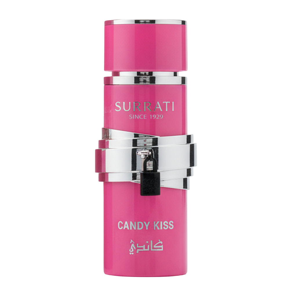 A pink cylindrical perfume bottle with silver metallic bands and a small black lock detail on the front, labeled 'Surrati Since 1929' and 'Candy Kiss' with Arabic script, on a plain white background.