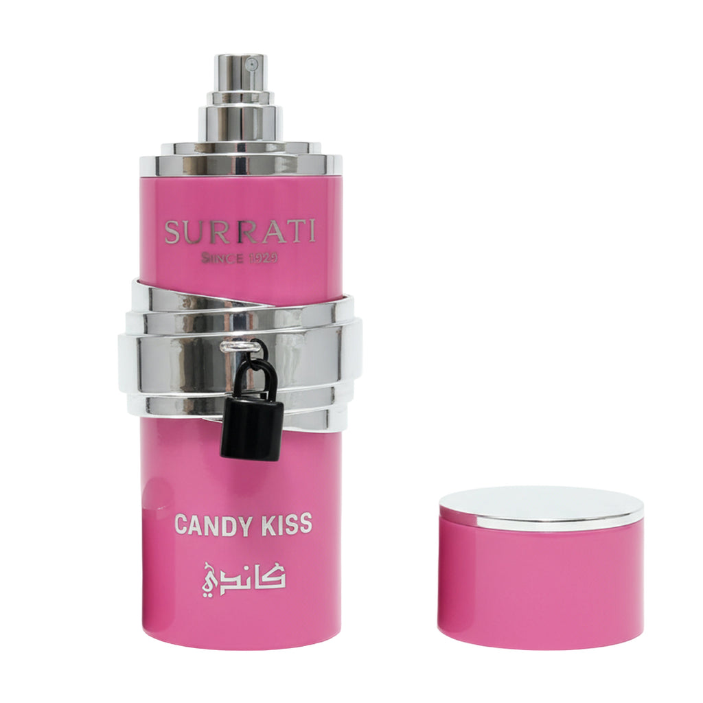 Pink and silver perfume bottle labeled 'Candy Kiss' by Surrati on a white background