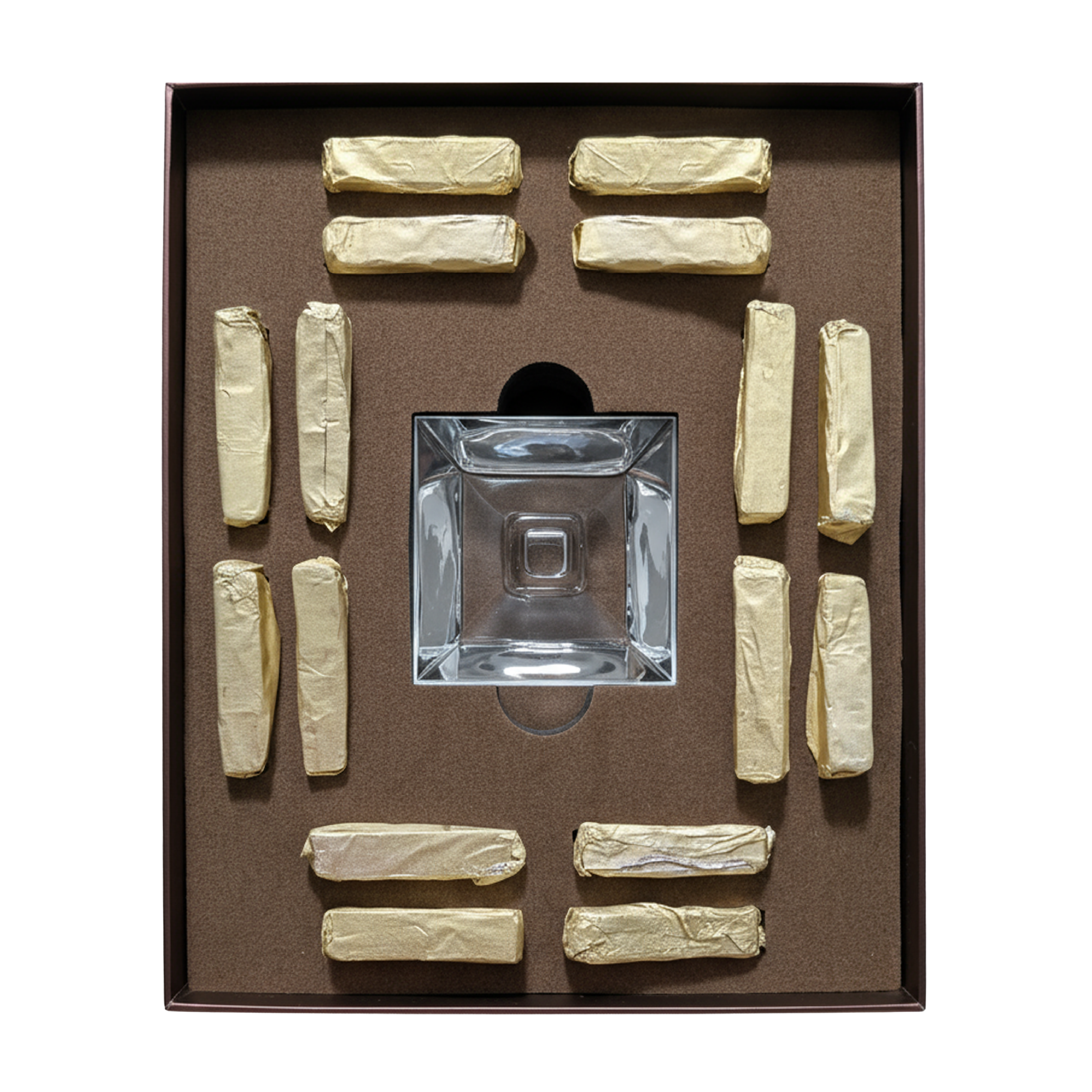 Crystal decanter with gold-colored stoppers arranged around it on a brown background