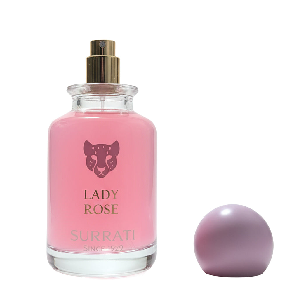 Pink Surrati Lady Rose perfume bottle with a matching pink sphere on a white background
