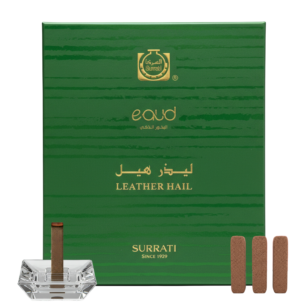 Green Surrati eau d'or box with incense sticks and a crystal holder on a white background