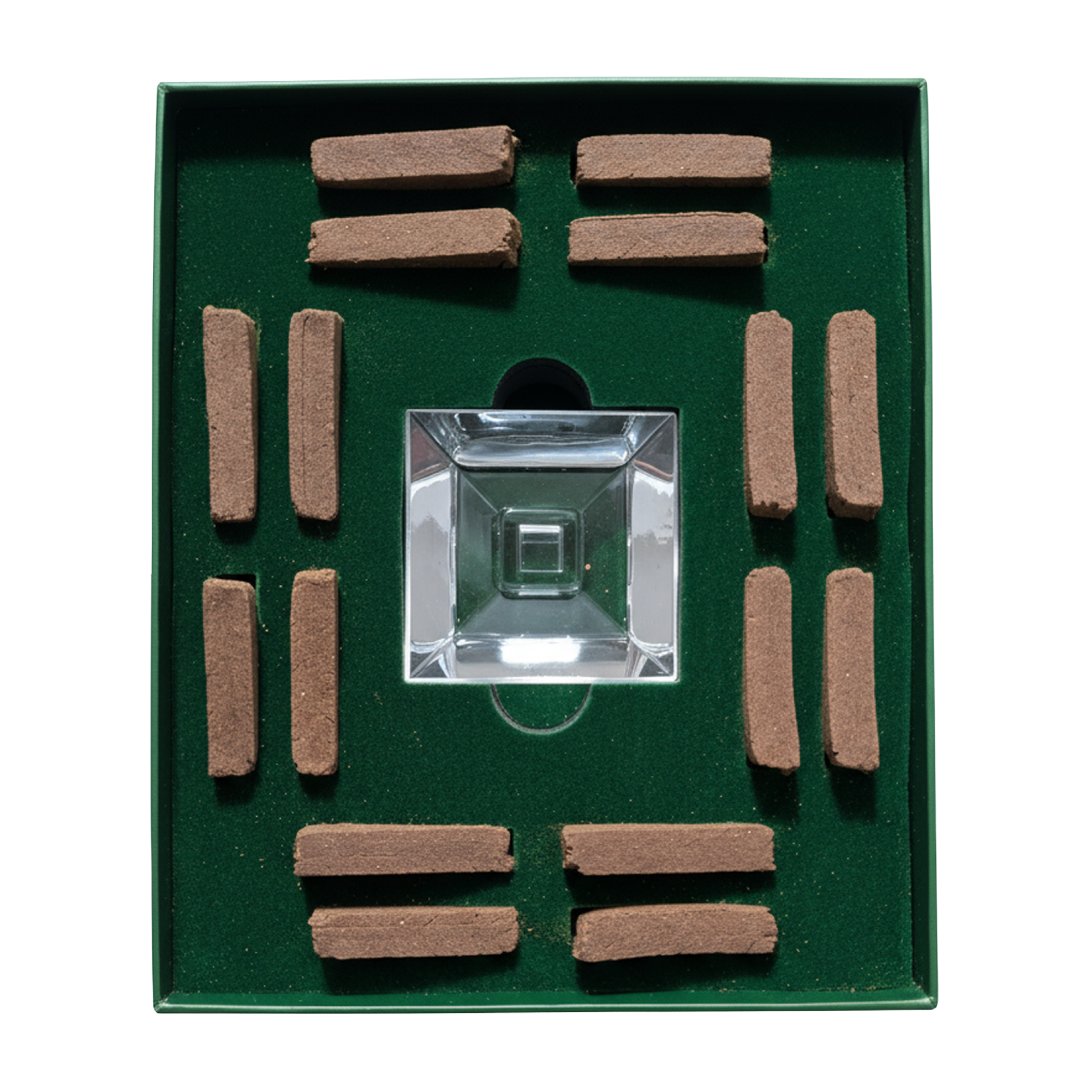 A square green presentation box containing a clear glass or acrylic square centerpiece surrounded by multiple small brown rectangular sticks, photographed on a plain white background.