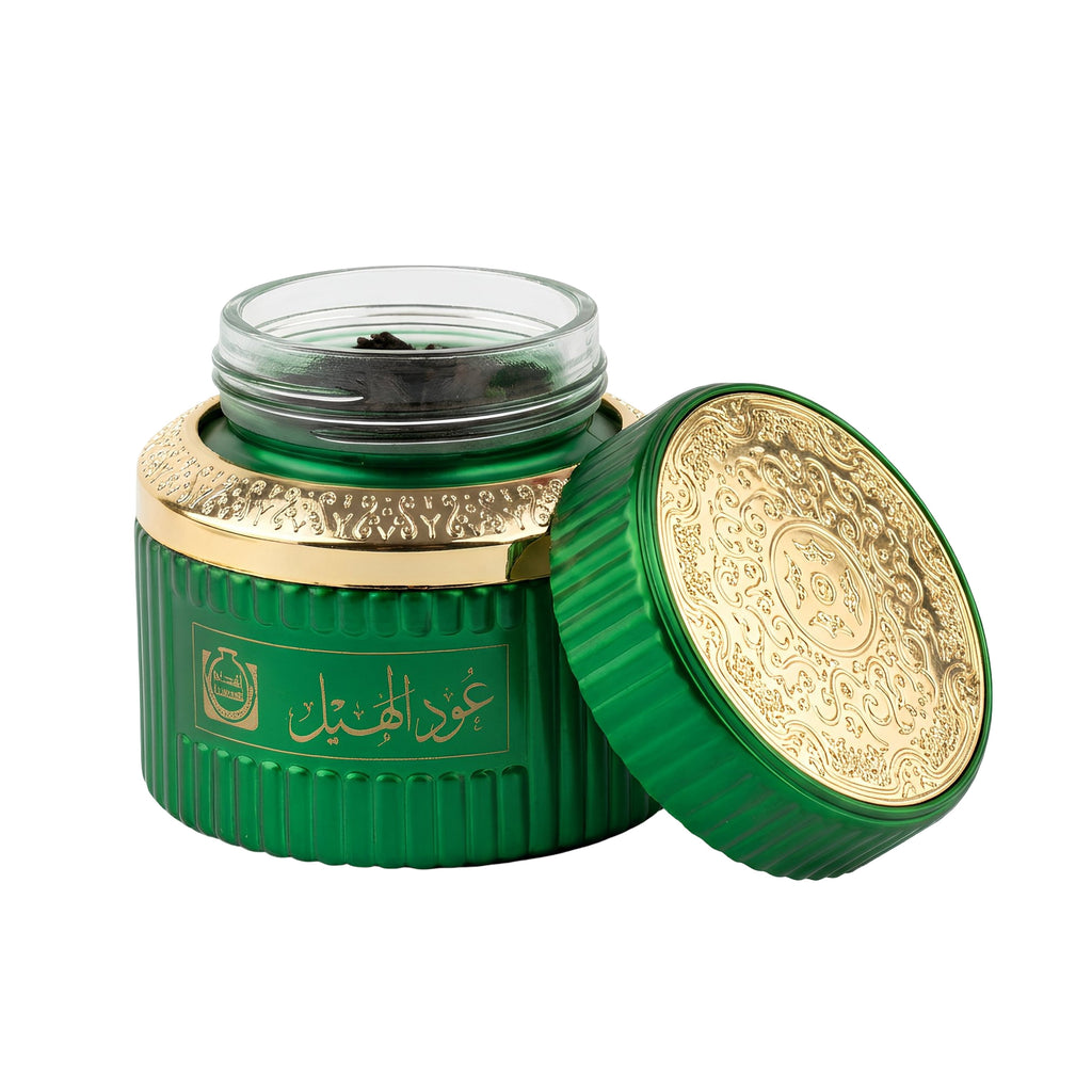 Green and gold container with intricate designs on a white background