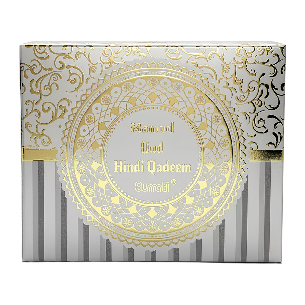 A square product box for Surati Diamond Dupat Hindi Qadeem, featuring a white and silver striped base with ornate gold foil patterns and a large central gold medallion.