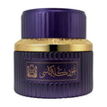 Purple and gold cosmetic jar with decorative design on a white background
