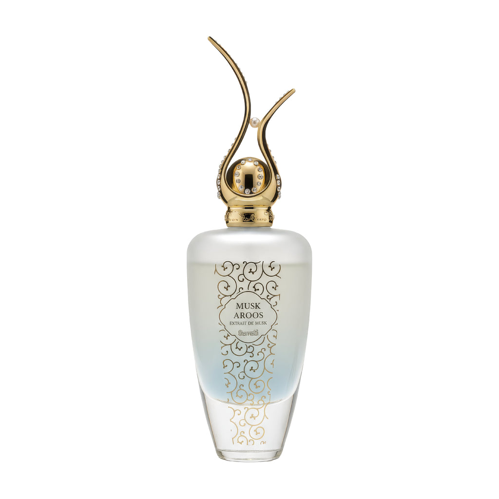 Benefit Muse Aroos perfume bottle with a frosted white and light blue gradient body, gold ornate scrollwork, and a distinctive gold double-horn cap on a white background.