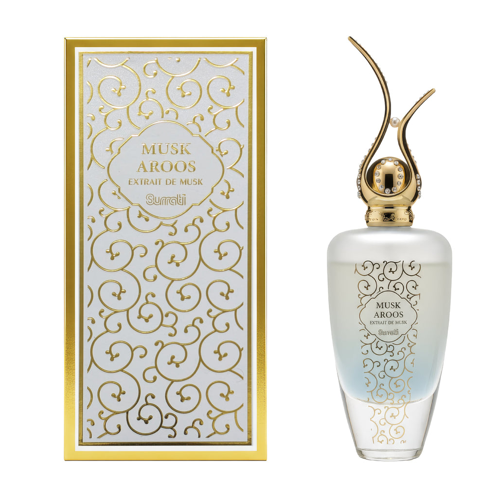 Perfume bottle and packaging with intricate designs on a white background