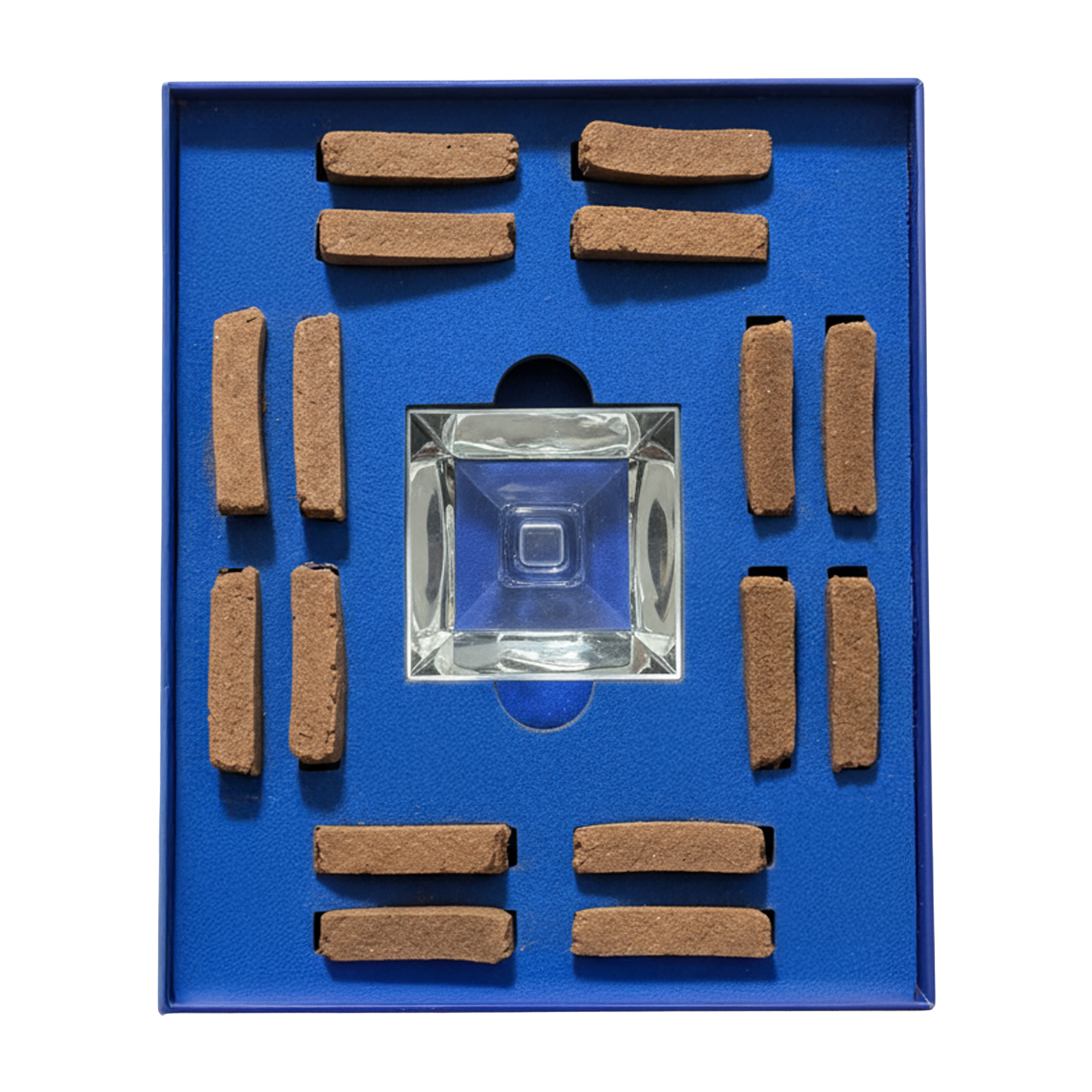 A square glass smoking pipe displayed in a blue presentation box with multiple brown rectangular tobacco pieces arranged around it.