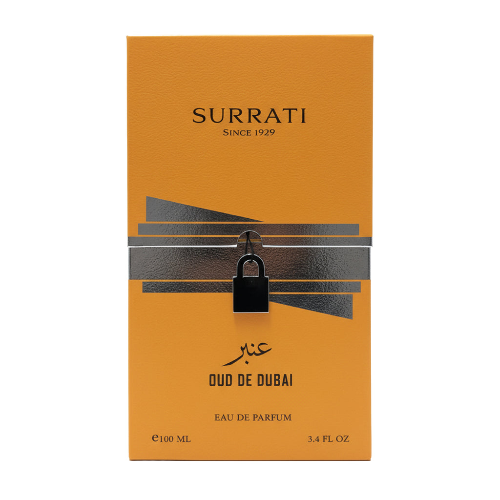 Surrati Oud de Dubai Eau de Parfum 100ml box in a vibrant orange color, featuring a metallic silver geometric band and a black padlock graphic in the center.