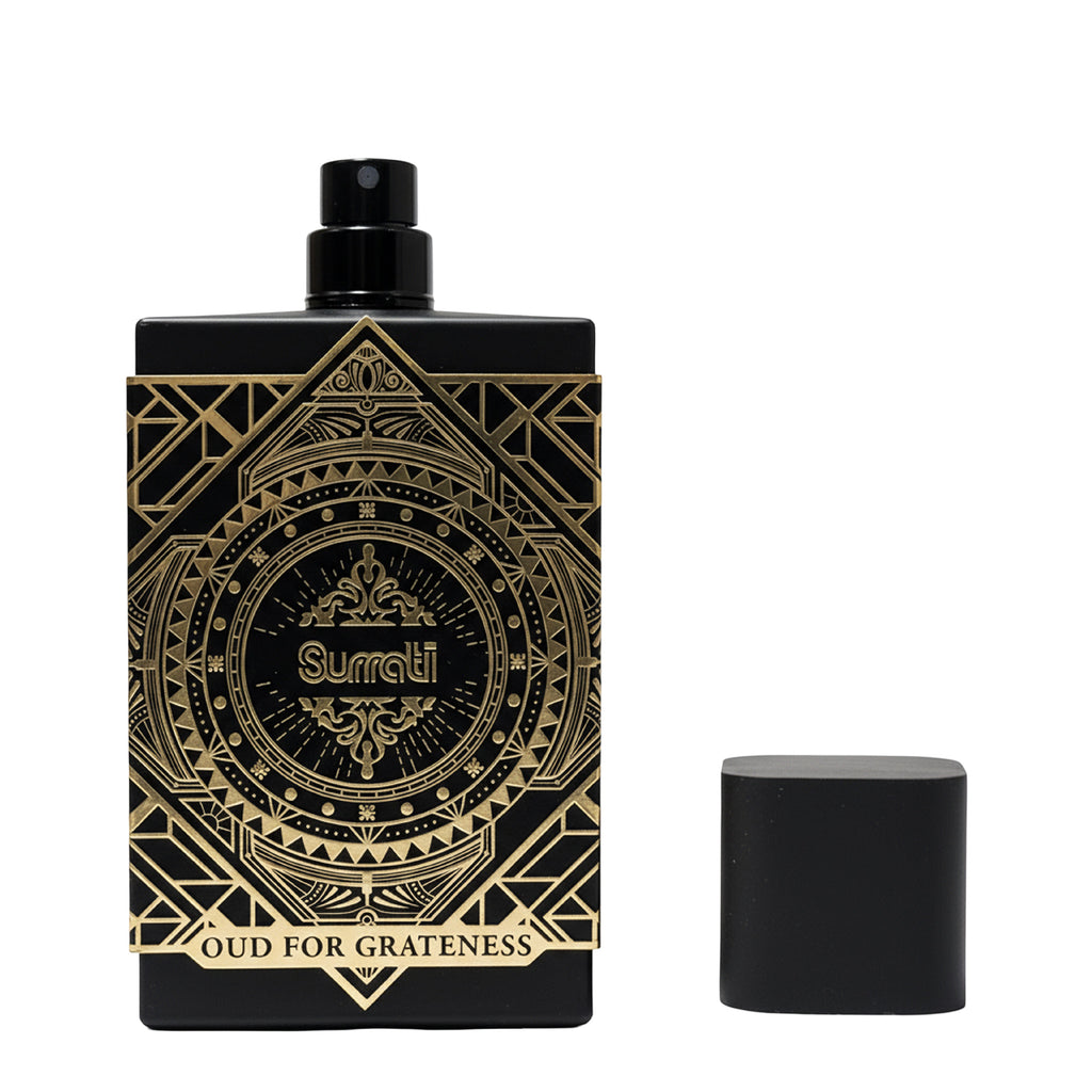 Black and gold Surrati perfume bottle on a white background