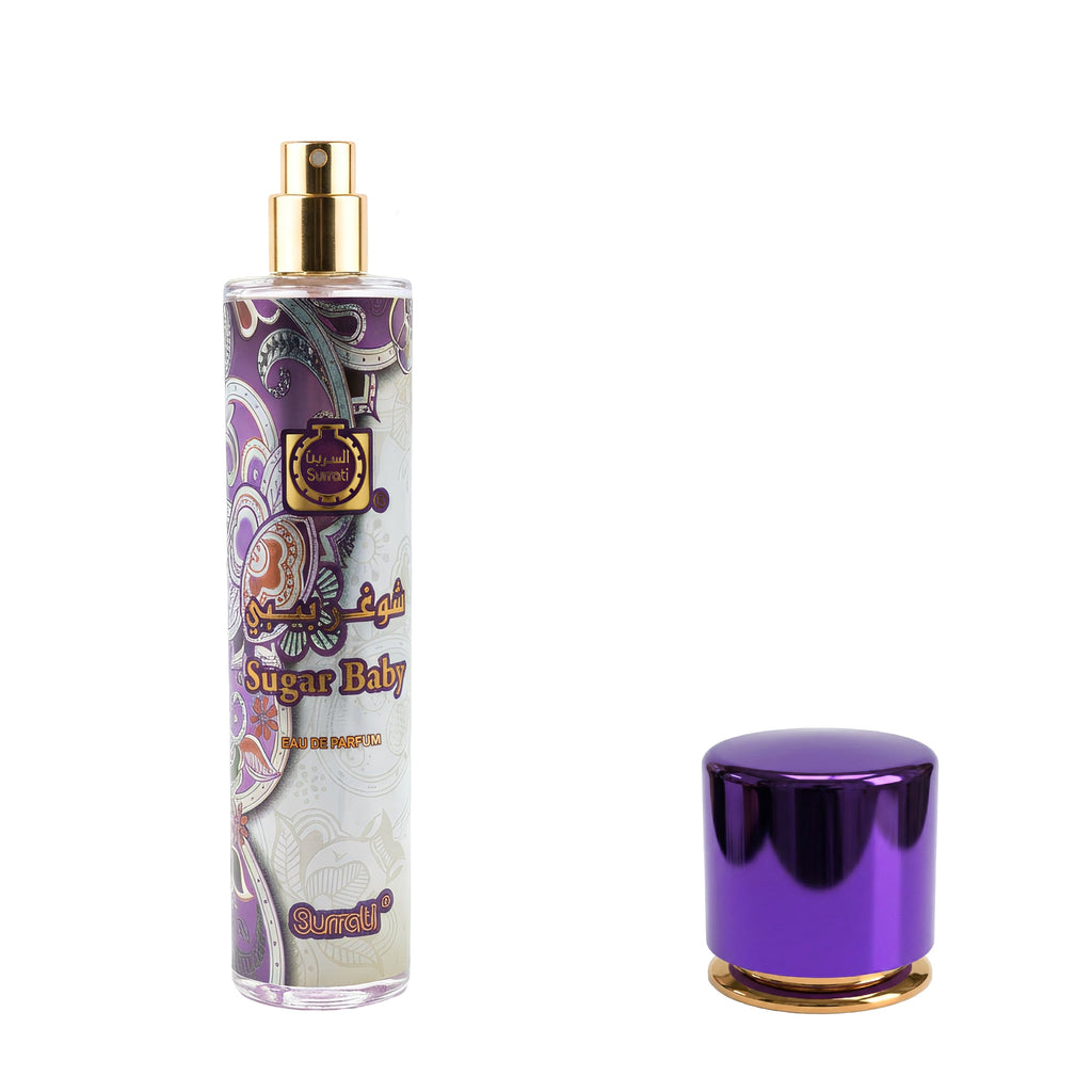 A clear cylindrical perfume bottle with a gold spray top and a purple ornamental label reading 'Sugar Baby' and 'Sarell', shown next to a detached metallic purple cap with a gold base on a white background.