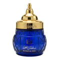 Blue perfume bottle with gold cap on a white background