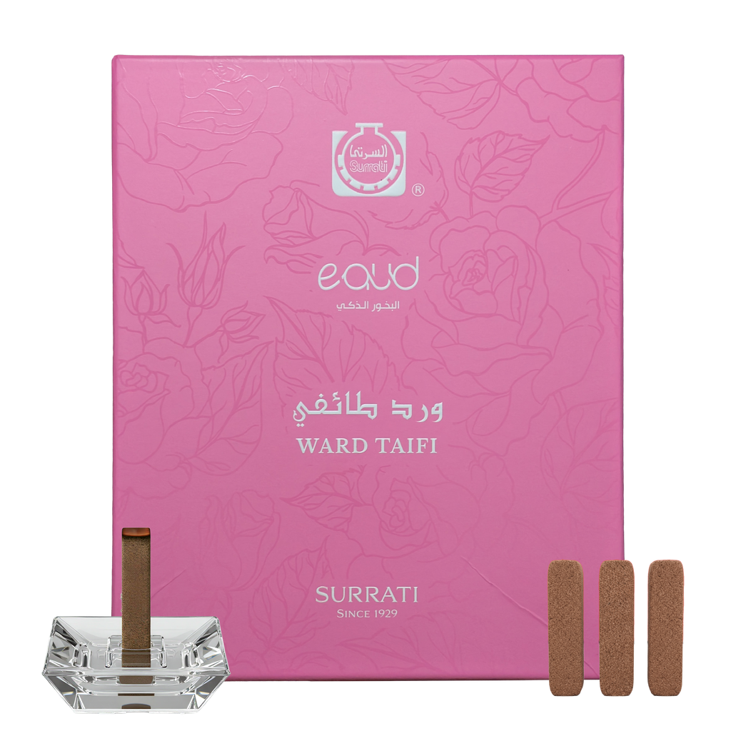 Pink Surrati eaud box with incense sticks and a crystal holder on a white background