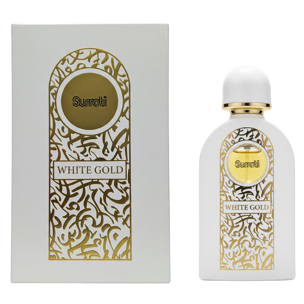Surrati White Gold perfume bottle next to its white and gold packaging box, featuring elegant Arabic calligraphy patterns.